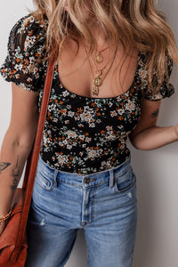 Bodysuit de la manga de hojaldre de estampado floral negro u cuello