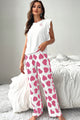 Top canotta rosa arruffato e pantaloni stampati a carico set