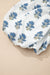 Mini vestido floral azul celeste com manga bufante amarrada no pescoço e bolso