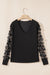 Blusa manga larga con cuello en V y malla con apliques de flores negra