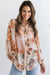 Camisa ligera con mangas abullonadas y estampado floral naranja