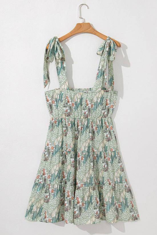 Mini-robe smockée à volants et bretelles nouées à fleurs grise