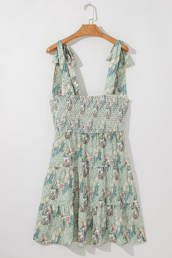 Mini-robe smockée à volants et bretelles nouées à fleurs grise