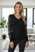 Blusa manga larga con cuello en V y malla con apliques de flores negra