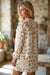 Mini-robe jaune à imprimé floral et col noué à volants et manches longues