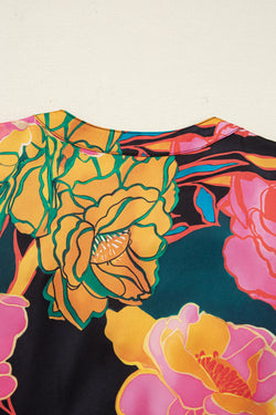 Camicetta con scollo a V e maniche a sbuffo con polsini smock con stampa floreale nera