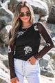 Top a manica lunga a maglia a maglie floreale nera